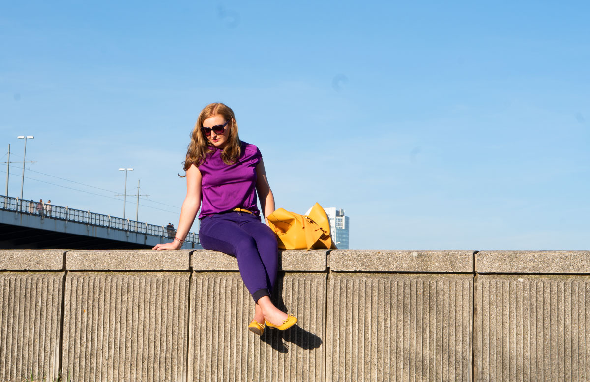 Meine-Trendfarben-2019-Outfit-Curry-und-Ultraviolett-rückenansicht-sizend-mit-seitlichem-blick-ganzkörper